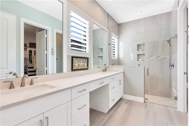 a spacious bathroom with a double vanity sink mirror and double