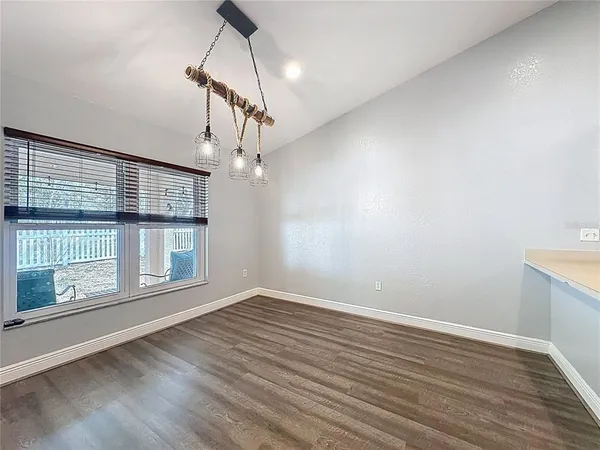 a large kitchen with stainless steel appliances wooden cabinets and a stove top oven