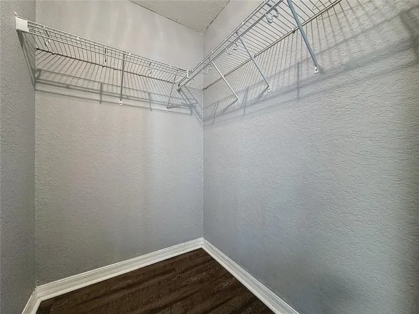 a view of a hallway with closet and wooden floor