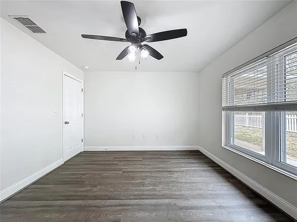 wooden floor in an empty room with a window