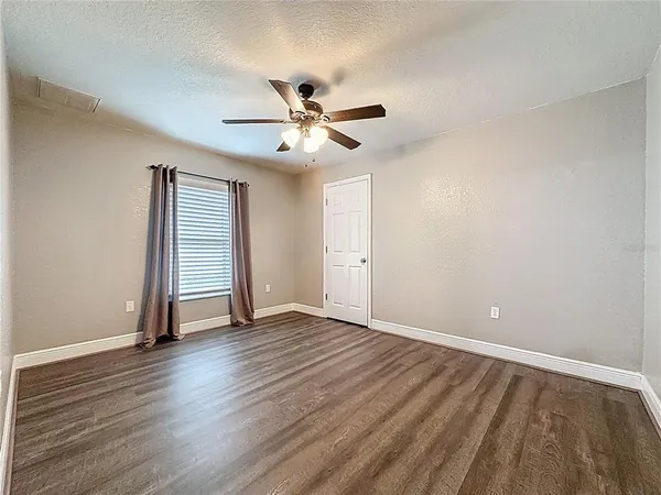 a view of a room with a ceiling fan and a ceiling fan