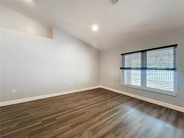 a view of an empty room and wooden floor