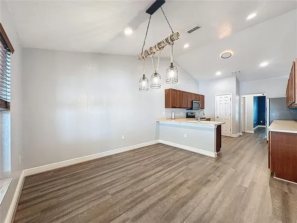 a kitchen with a sink a counter top space stainless steel appliances and cabinets