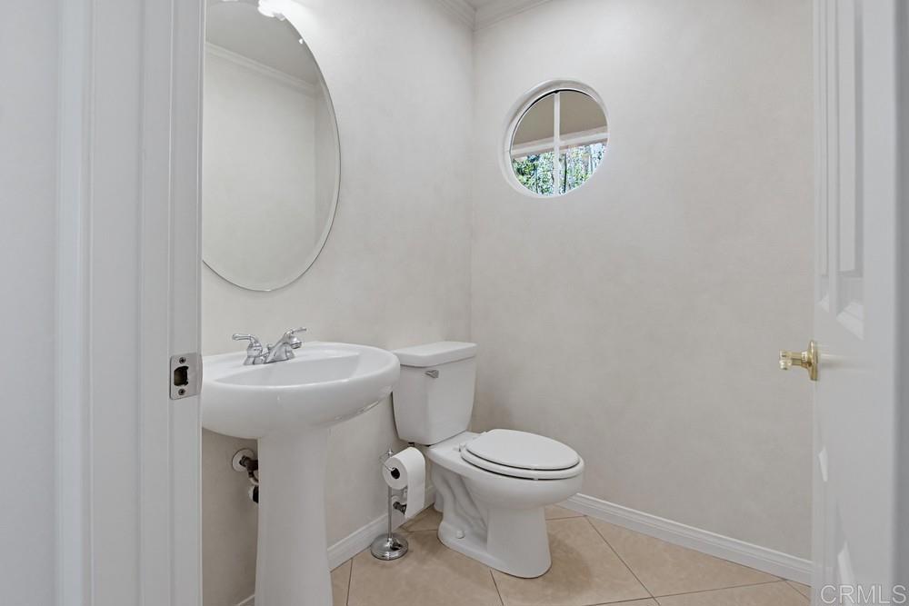 672 Inverlochy Drive Fallbrook, CA 92028 - Photo 27 of 75 a bathroom with a toilet sink and mirror