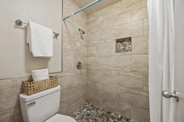a bathroom with a toilet sink and shower