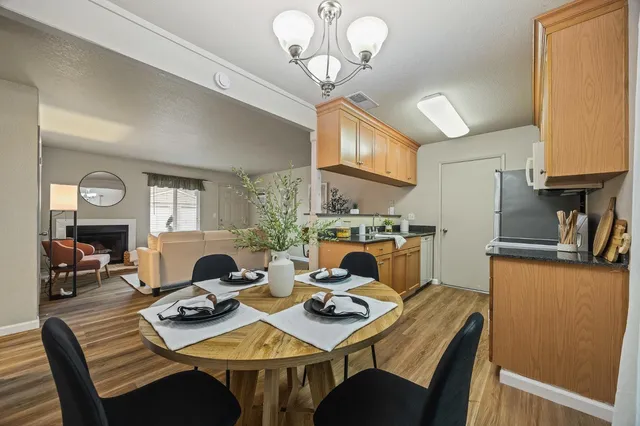 a view of a dining room with furniture a chandelier and wooden floor