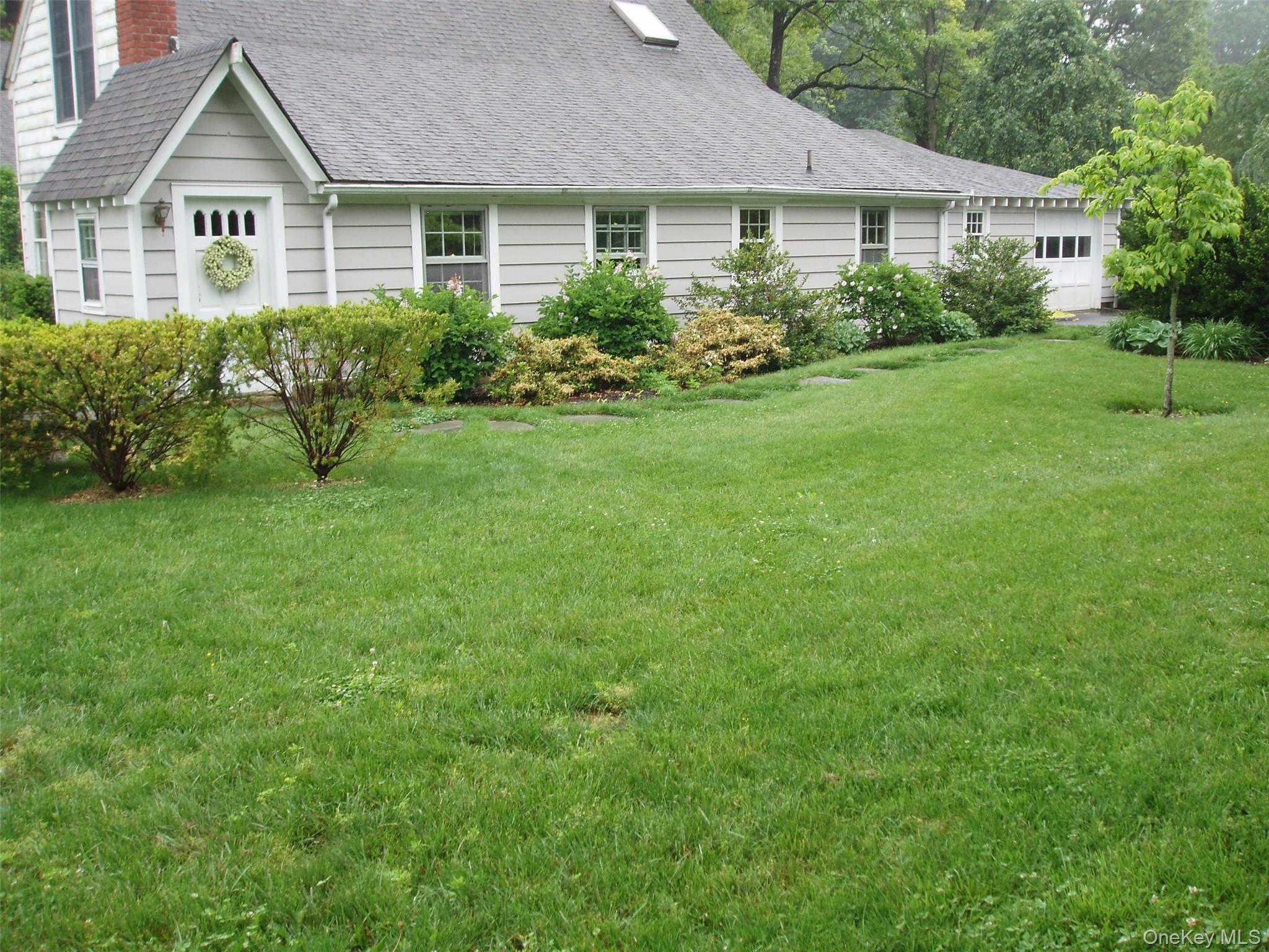 953 Ripley Lane Oyster Bay, NY 11771 - Photo 1 of 21 a front view of a house with a yard and green space