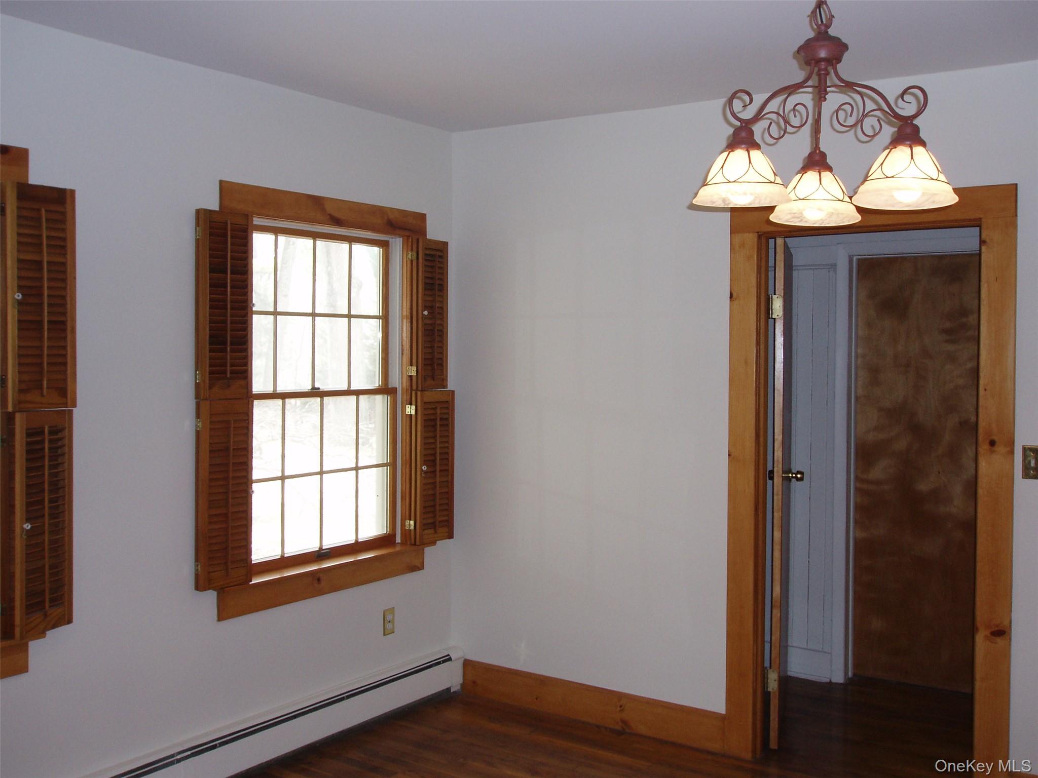 953 Ripley Lane Oyster Bay, NY 11771 - Photo 11 of 21 wooden floor in an empty room with a window