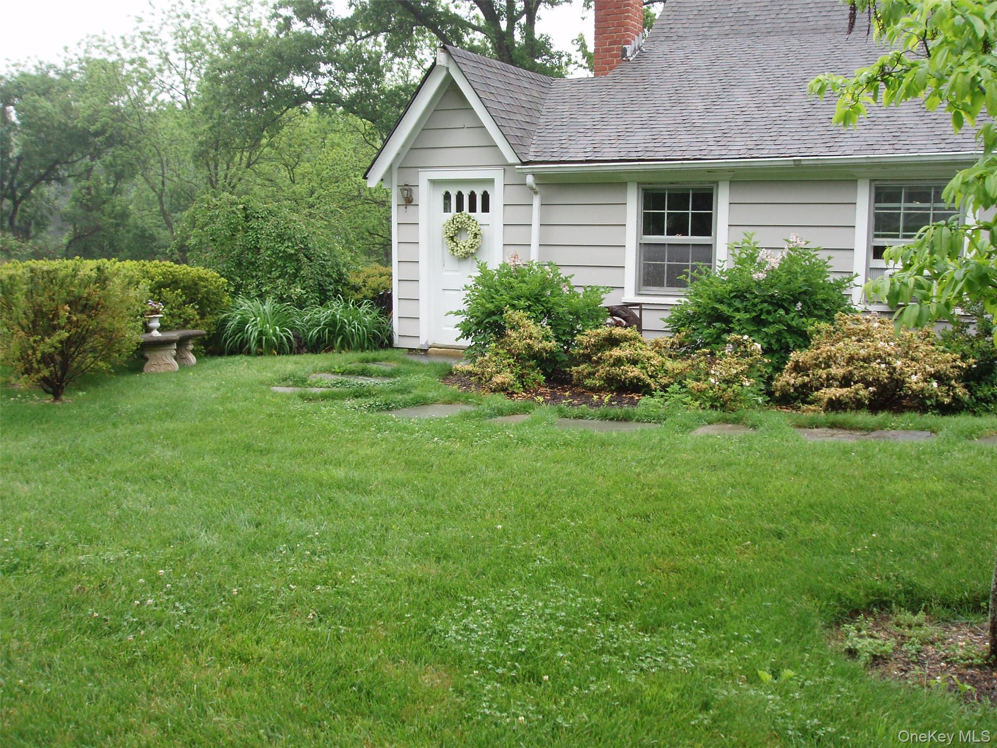 953 Ripley Lane Oyster Bay, NY 11771 - Photo 2 of 21 front view of a house with a yard