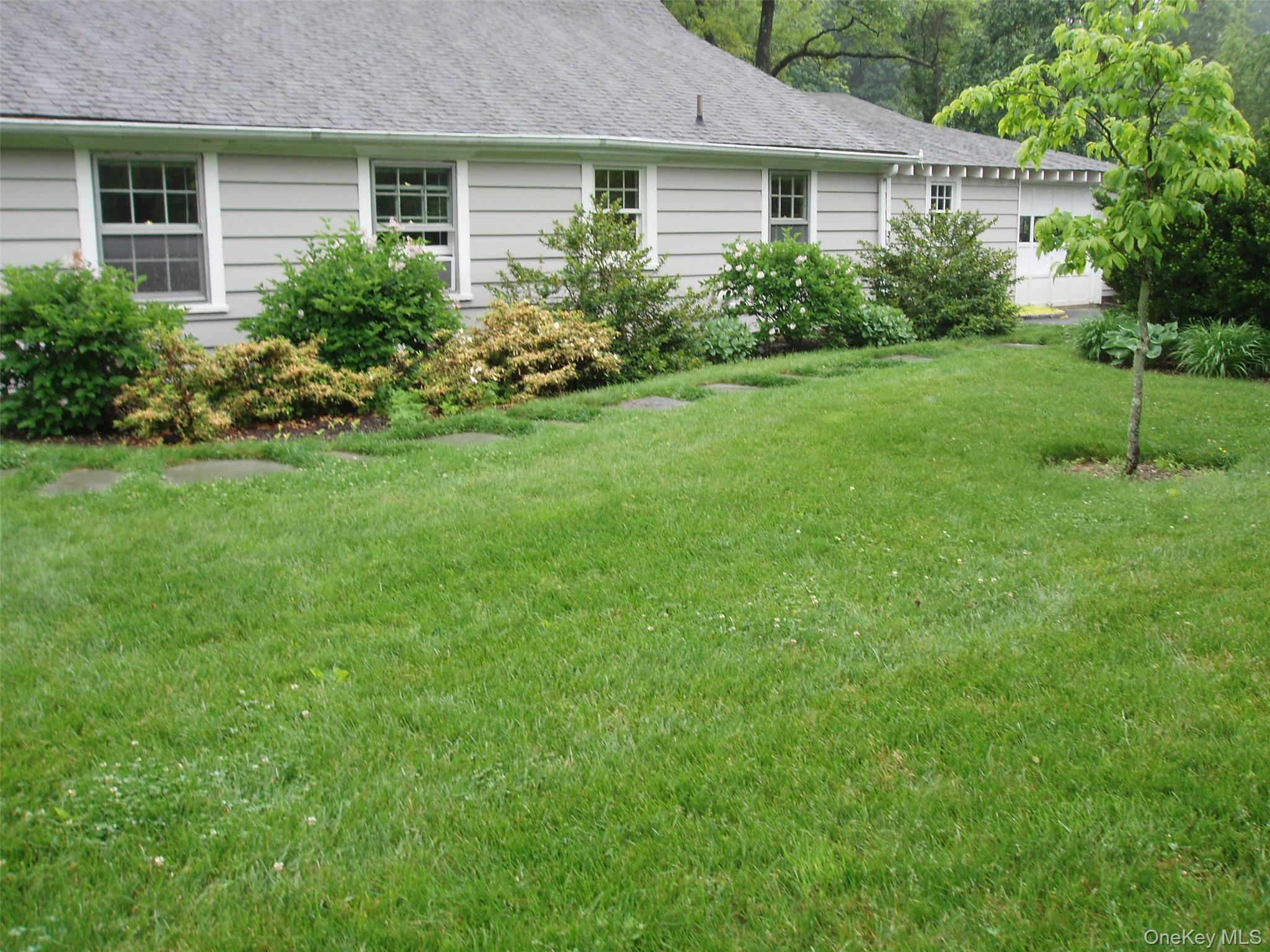 953 Ripley Lane Oyster Bay, NY 11771 - Photo 3 of 21 a house view with a garden space