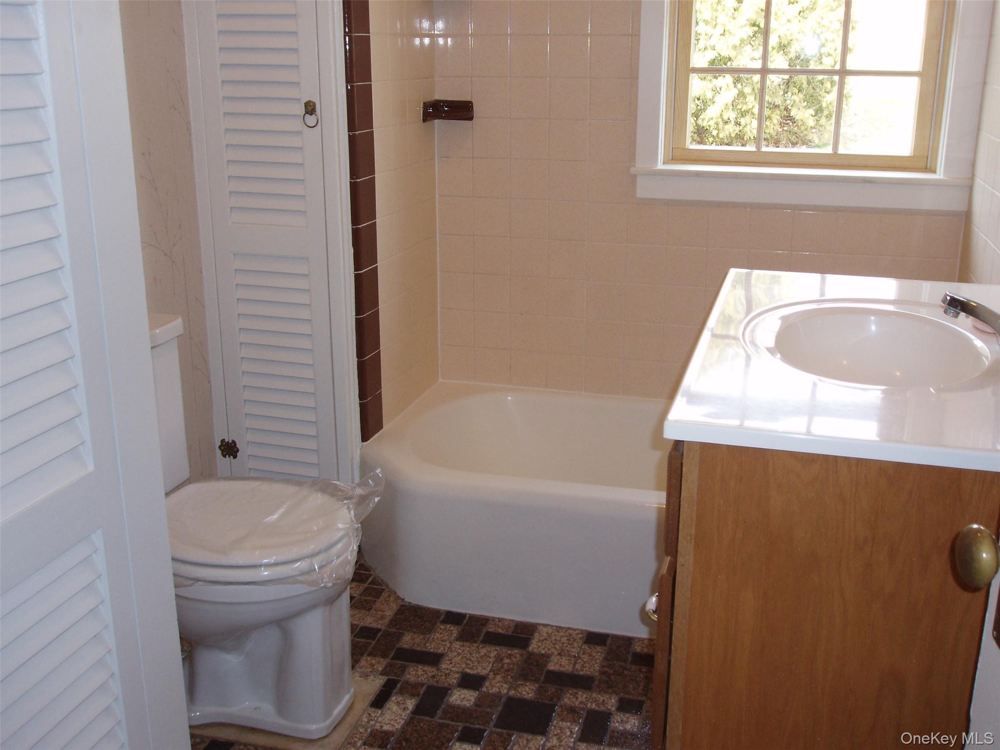 953 Ripley Lane Oyster Bay, NY 11771 - Photo 7 of 21 a bathroom with a sink toilet and shower