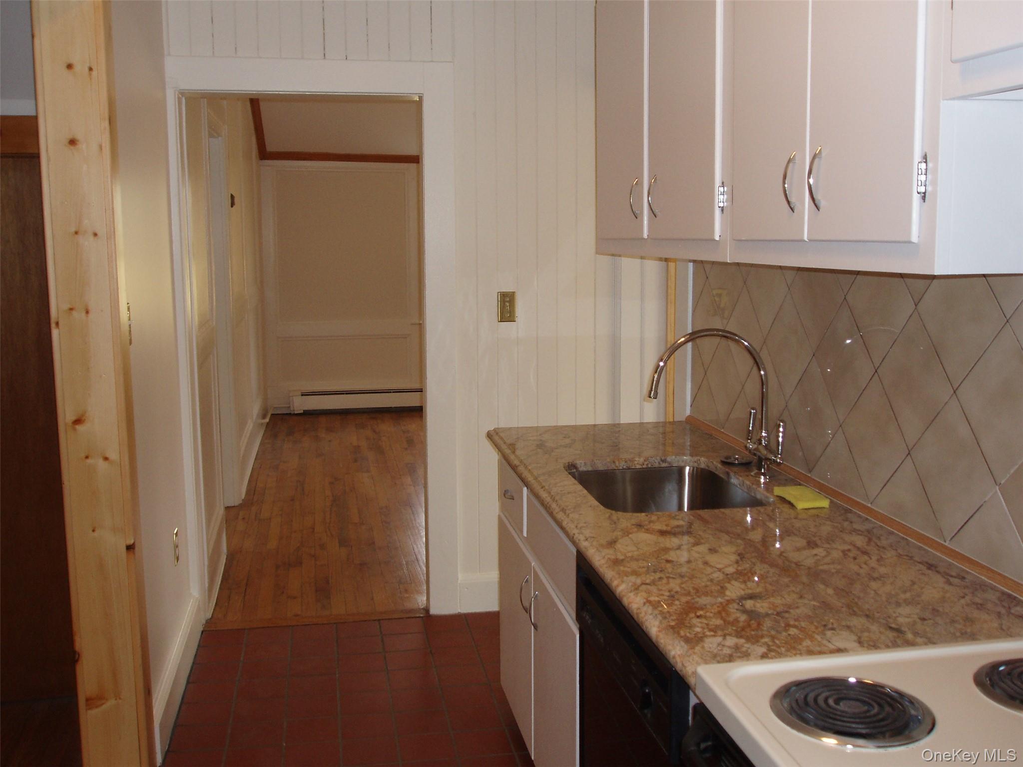 953 Ripley Lane Oyster Bay, NY 11771 - Photo 8 of 21 a kitchen with a sink and cabinets