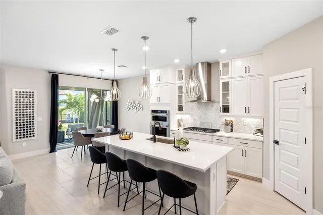 a kitchen with stainless steel appliances granite countertop a sink and a stove