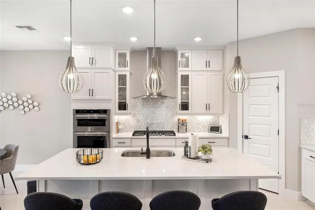a dining room with furniture a chandelier and window