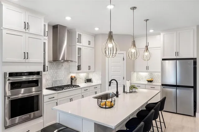 a very nice looking kitchen with a table chairs and a wooden floor