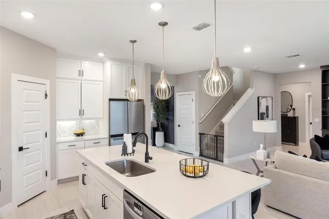 a kitchen with a stove a sink and a refrigerator