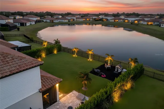 an aerial view of lake residential house with outdoor space and seating