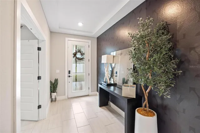 a bedroom with furniture and a large window