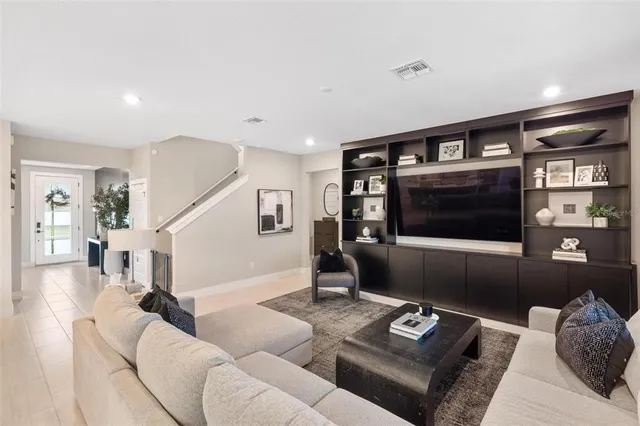 a living room with furniture and a view of kitchen