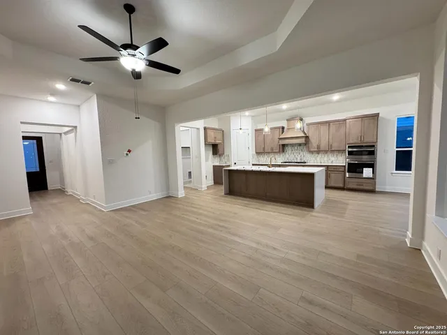 a view of hallway with wooden floor