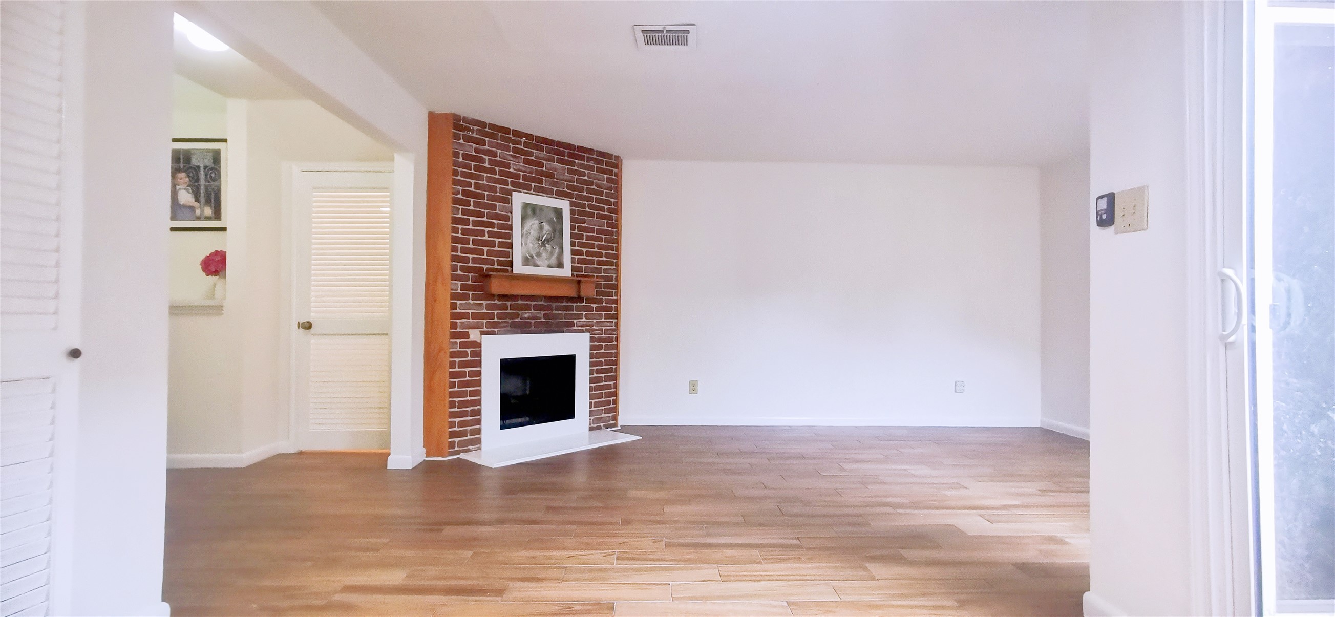 8313 Augustine Drive, Unit B Houston, TX 77036 - Photo 11 of 34 a view of an empty room with wooden floor and a window