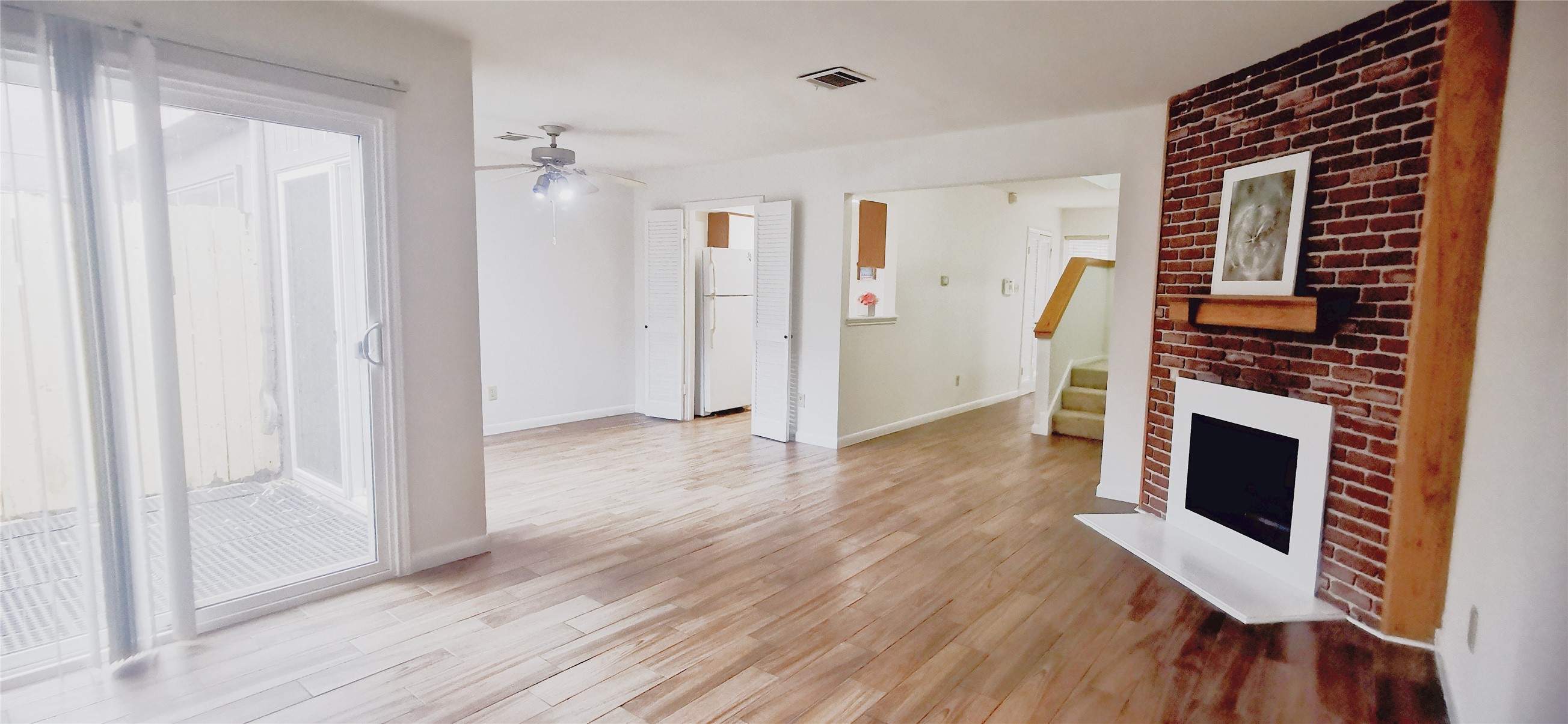 8313 Augustine Drive, Unit B Houston, TX 77036 - Photo 13 of 34 a view of a livingroom with wooden floor and a fireplace