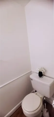 a white toilet sitting next to a shower