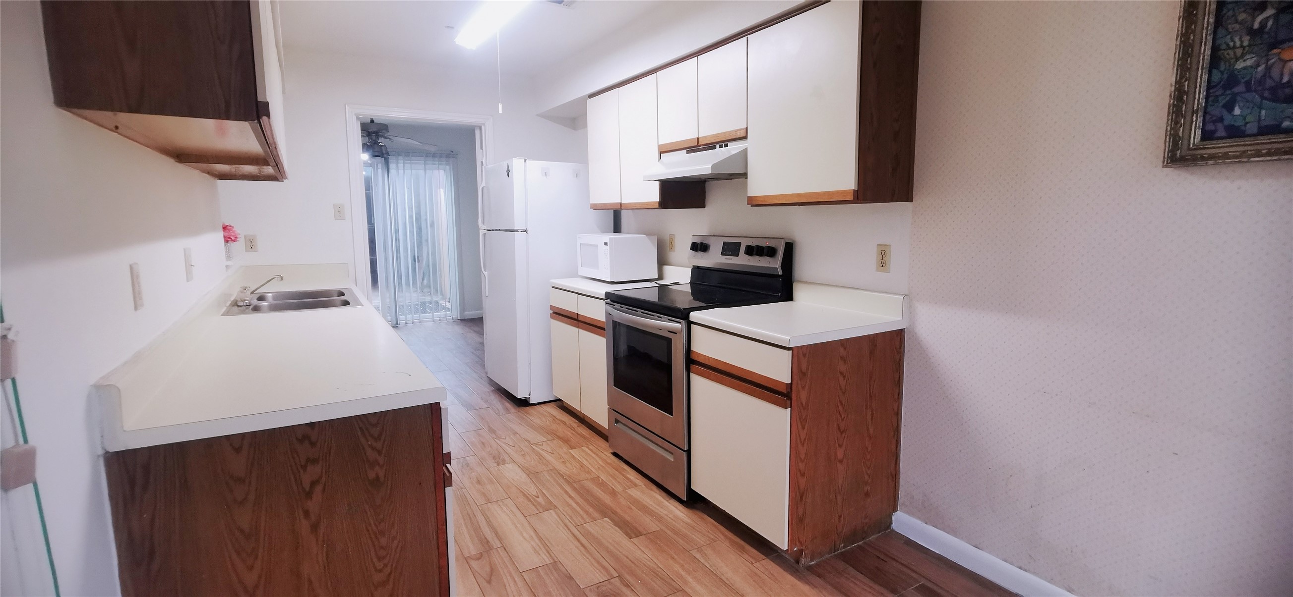 8313 Augustine Drive, Unit B Houston, TX 77036 - Photo 6 of 34 a kitchen with stainless steel appliances a sink stove and refrigerator