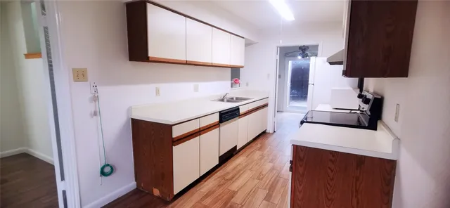 a kitchen with stainless steel appliances a sink and a refrigerator