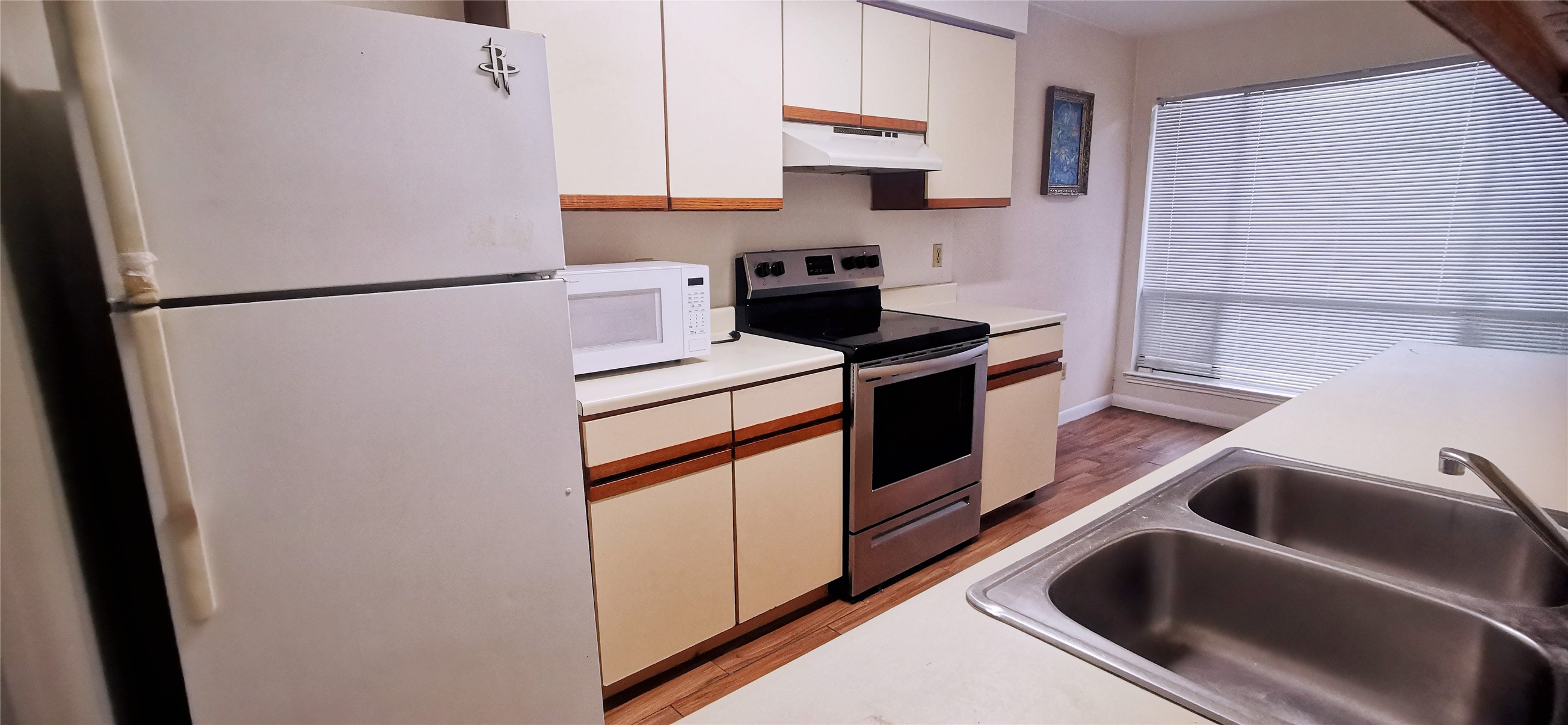 8313 Augustine Drive, Unit B Houston, TX 77036 - Photo 8 of 34 a kitchen with stainless steel appliances granite countertop a sink stove and refrigerator