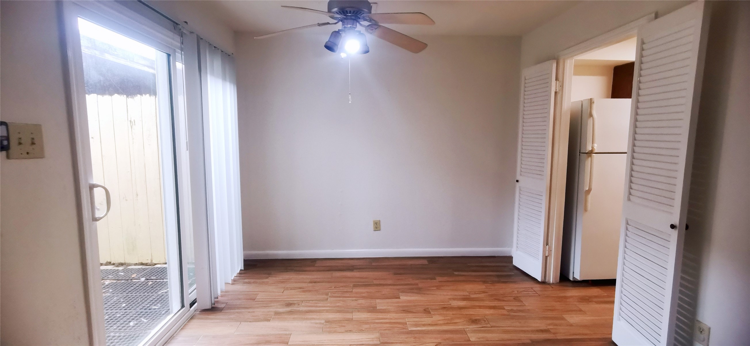 8313 Augustine Drive, Unit B Houston, TX 77036 - Photo 9 of 34 an empty room with wooden floor and a window