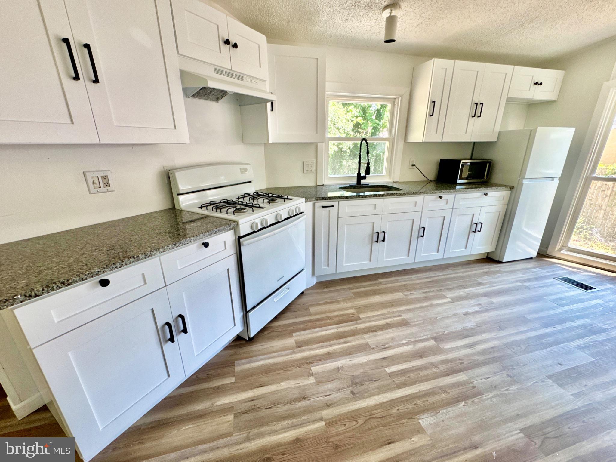 448 Evergreen Road Millville, NJ 08332 - Photo 8 of 25 a kitchen with stainless steel appliances white cabinets and a stove
