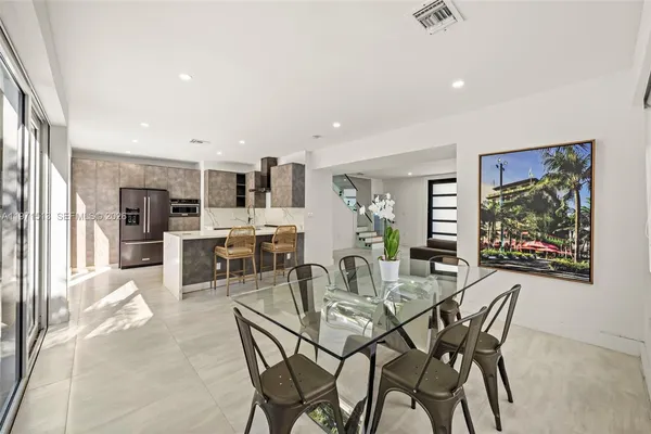a view of a dining room with furniture and a kitchen