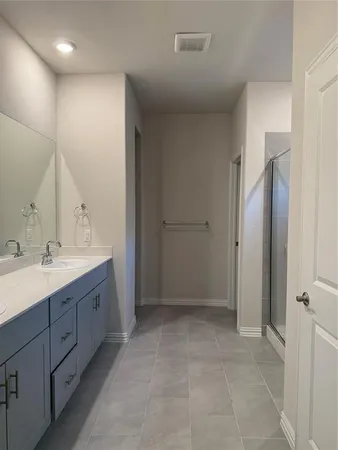a bathroom with a double vanity sink mirror and double