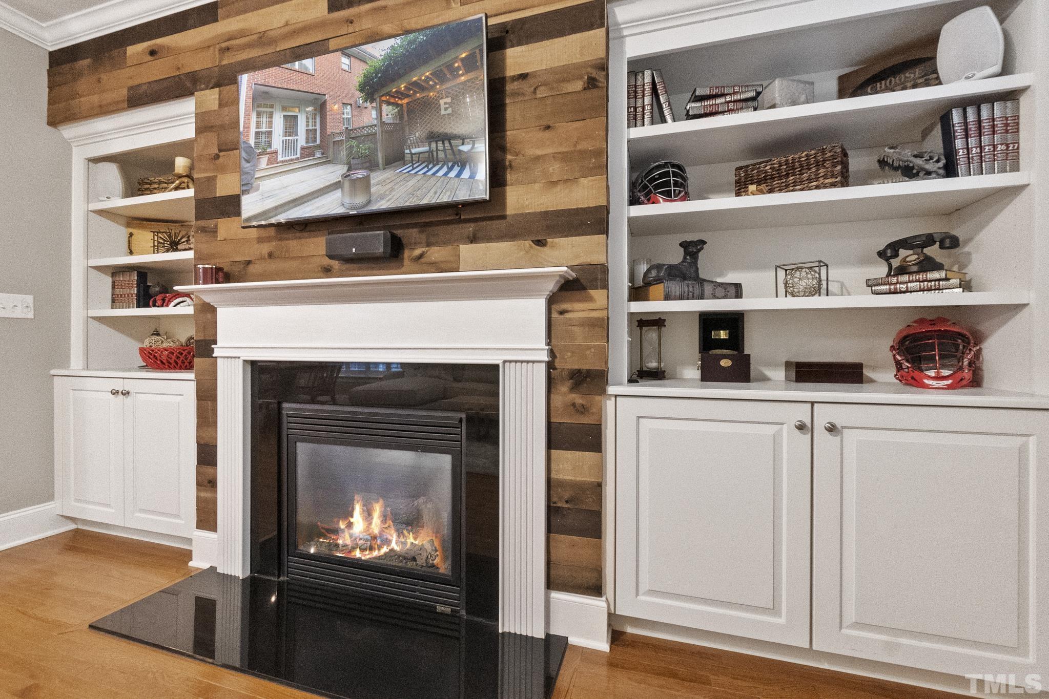 617 Highpark Lane Raleigh, NC 27608 - Photo 11 of 26 a kitchen with white cabinets and a fireplace