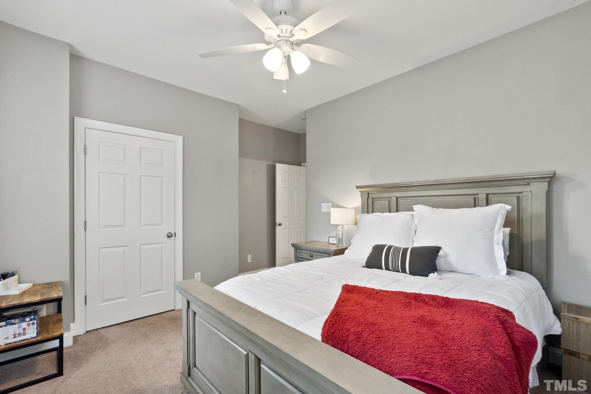 617 Highpark Lane Raleigh, NC 27608 - Photo 20 of 26 a bedroom with a large bed and a chandelier