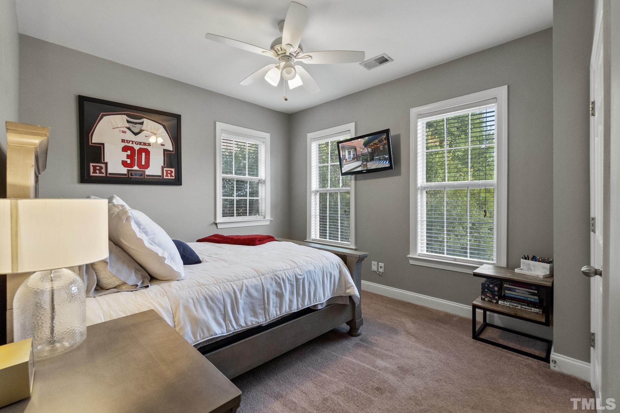 617 Highpark Lane Raleigh, NC 27608 - Photo 21 of 26 a bedroom with a bed and a window