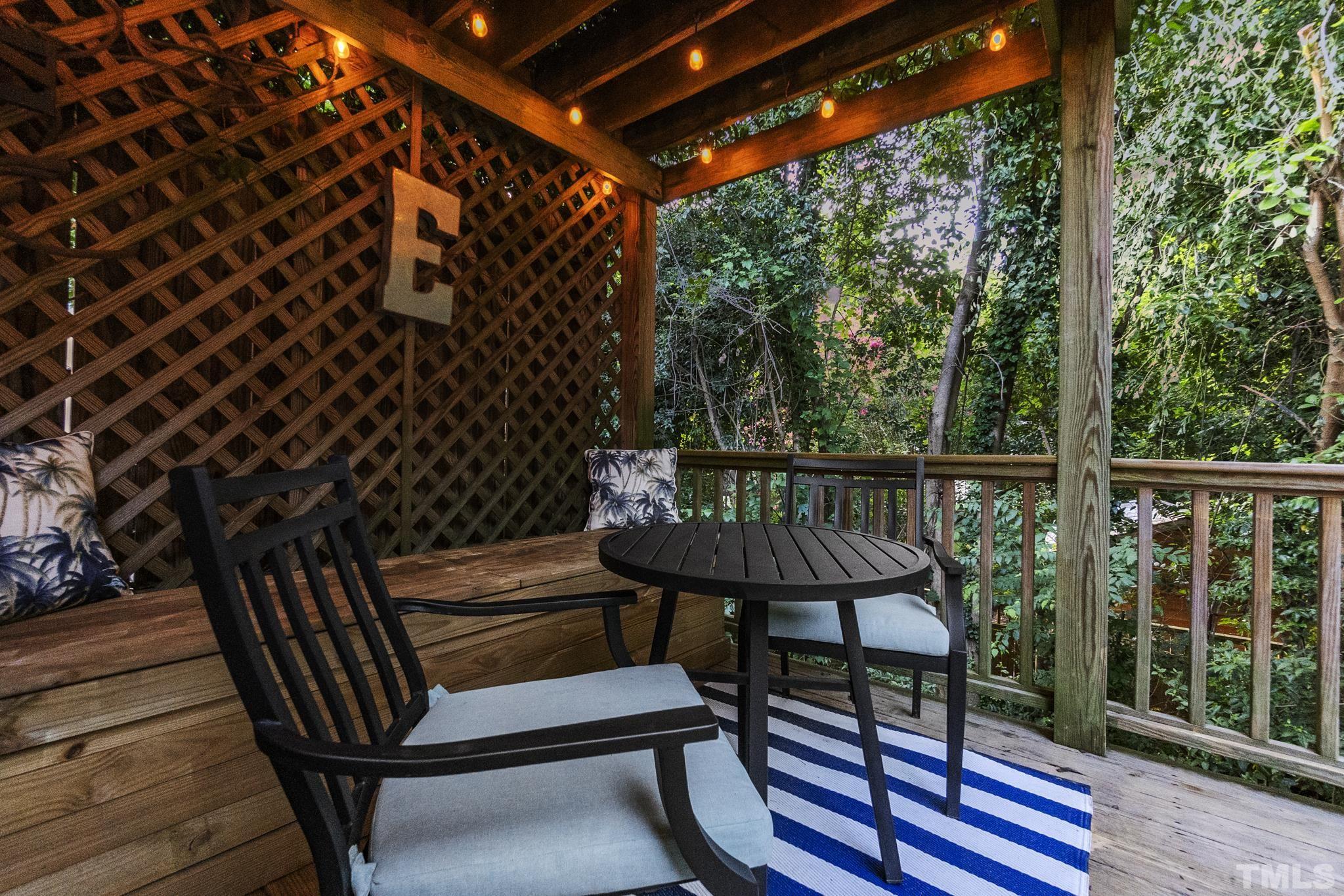 617 Highpark Lane Raleigh, NC 27608 - Photo 25 of 26 a view of balcony with wooden floor and outdoor seating