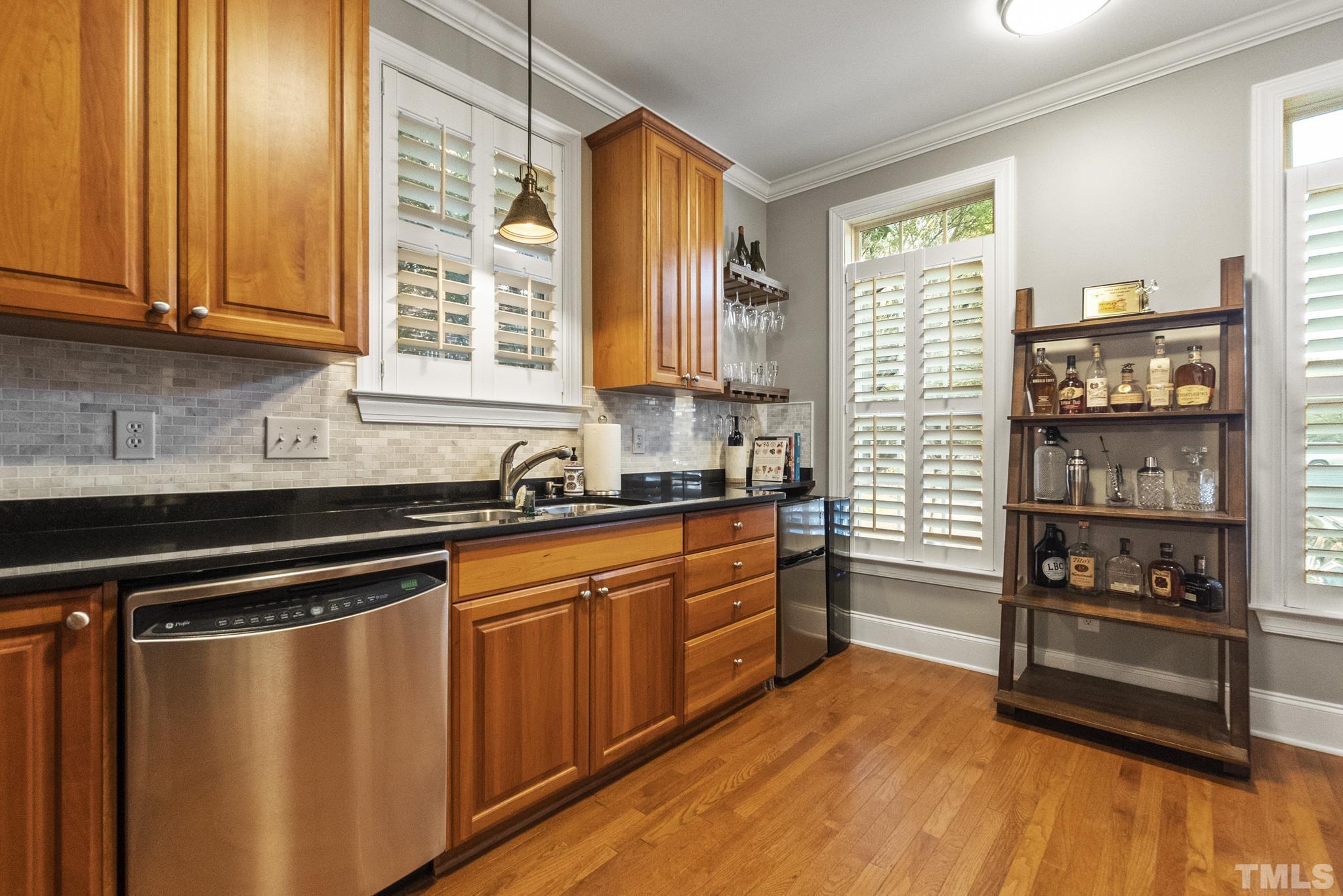 617 Highpark Lane Raleigh, NC 27608 - Photo 5 of 26 a kitchen with stainless steel appliances a sink cabinets and a large window