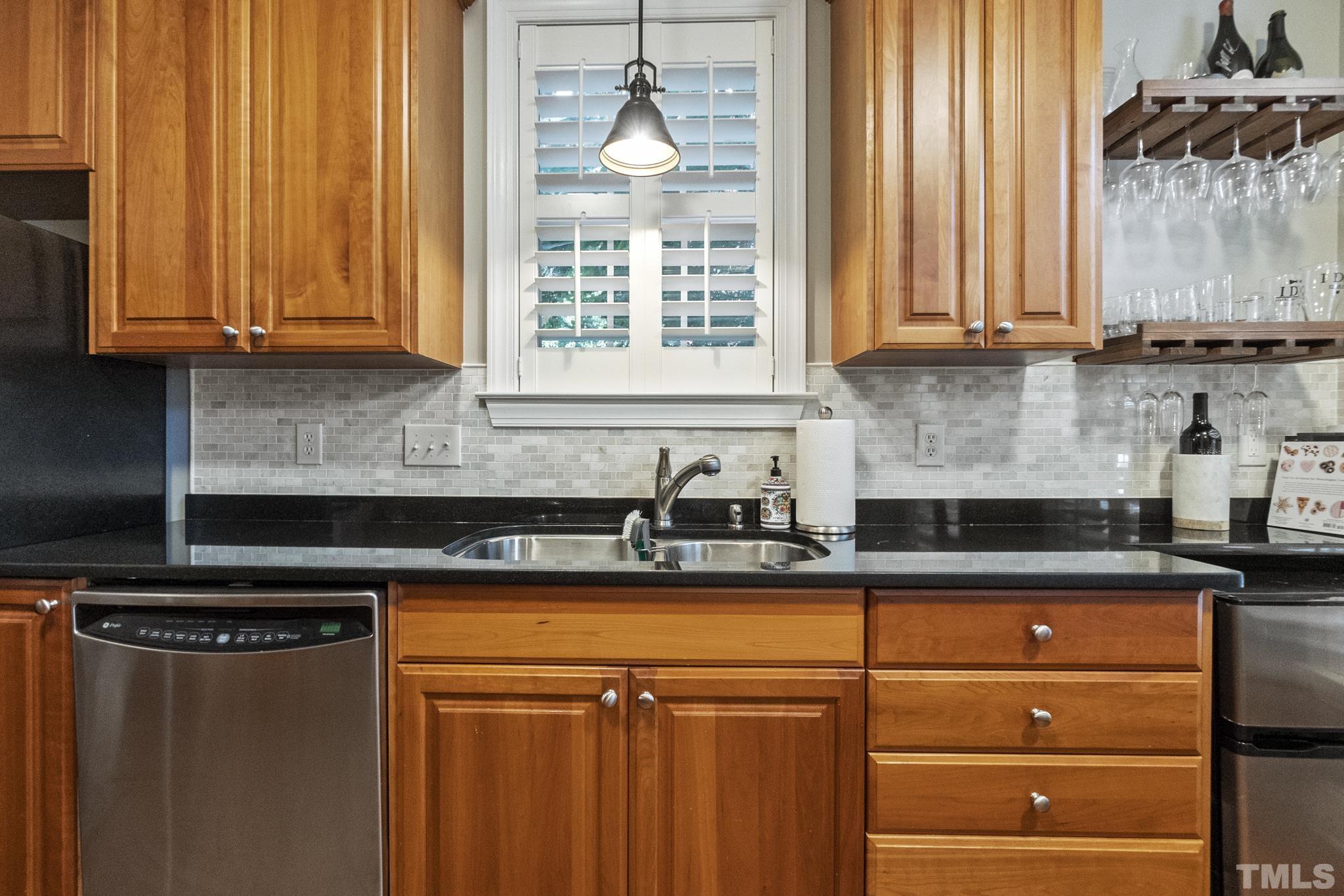 617 Highpark Lane Raleigh, NC 27608 - Photo 6 of 26 a kitchen with granite countertop cabinets stainless steel appliances a sink and a window