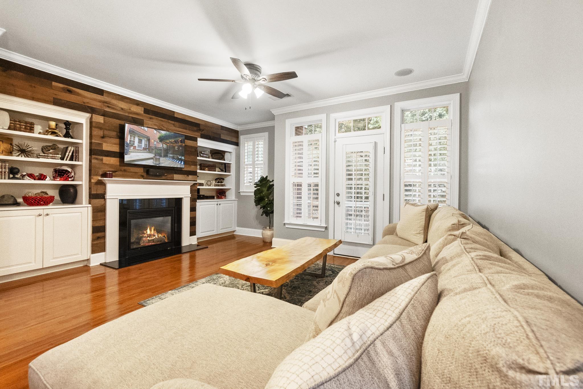 617 Highpark Lane Raleigh, NC 27608 - Photo 10 of 26 a bedroom with a large bed and a fireplace