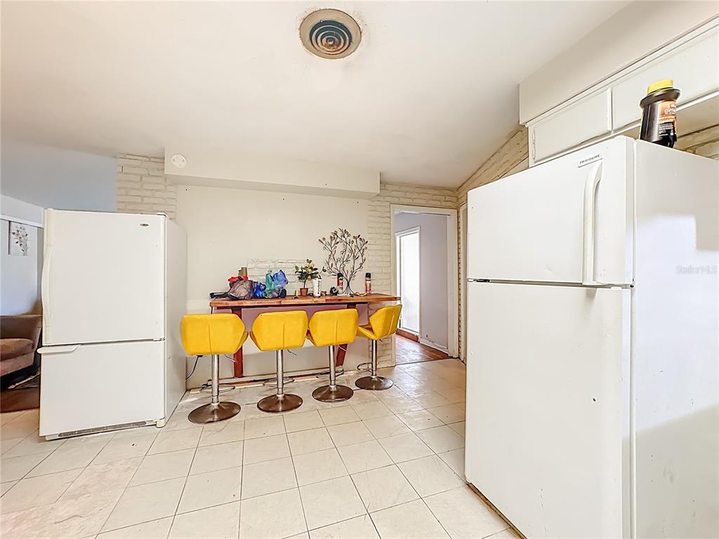 4200 Anderson Road Orlando, FL 32812 - Photo 13 of 63 a view of a kitchen with furniture and refrigerator