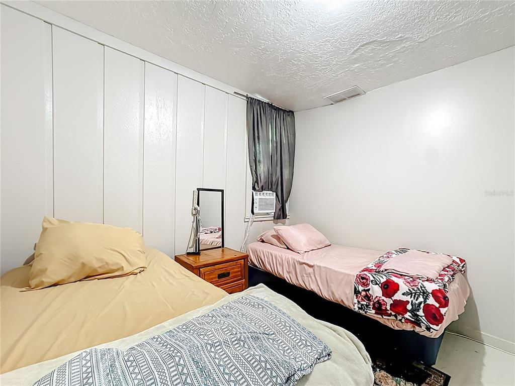 4200 Anderson Road Orlando, FL 32812 - Photo 20 of 63 a bedroom with two beds and a couch