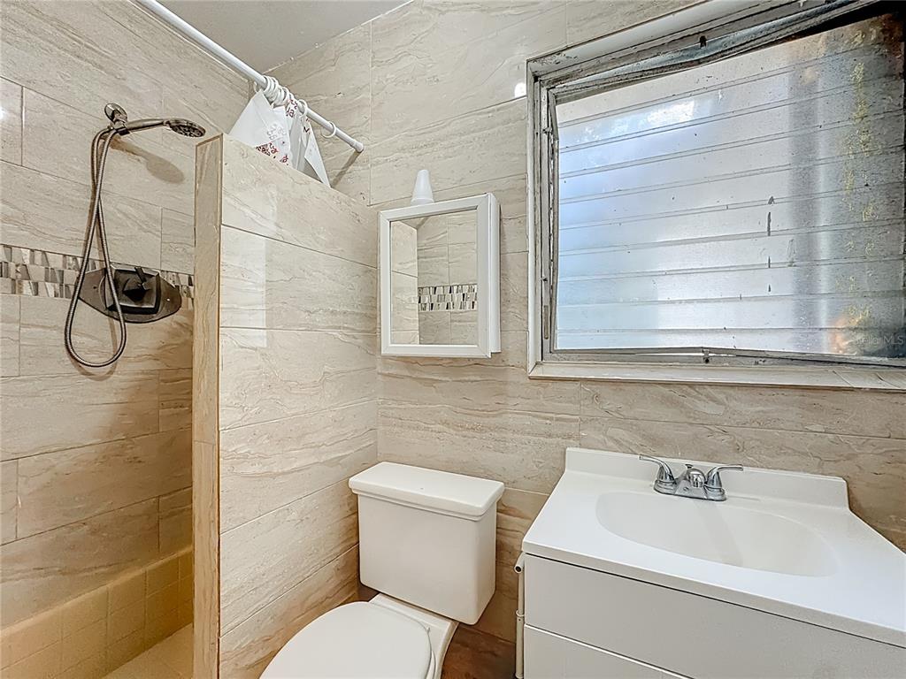 4200 Anderson Road Orlando, FL 32812 - Photo 22 of 63 a bathroom with a toilet sink and shower