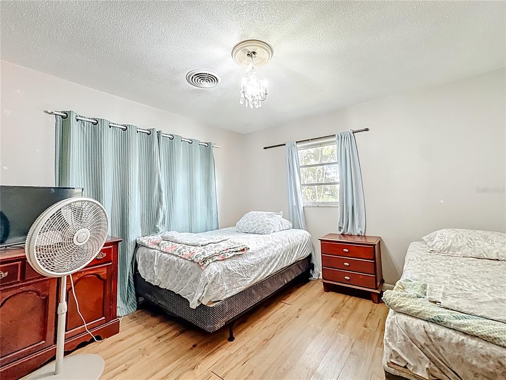 4200 Anderson Road Orlando, FL 32812 - Photo 25 of 63 a bedroom with a bed chair and a window
