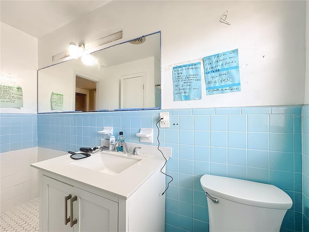 4200 Anderson Road Orlando, FL 32812 - Photo 29 of 63 a bathroom with a sink a toilet and a mirror