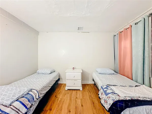 a white toilet sitting next to a white sink and a shower curtain