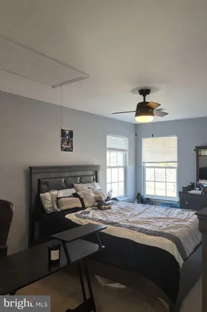 a living room with furniture a rug and a window