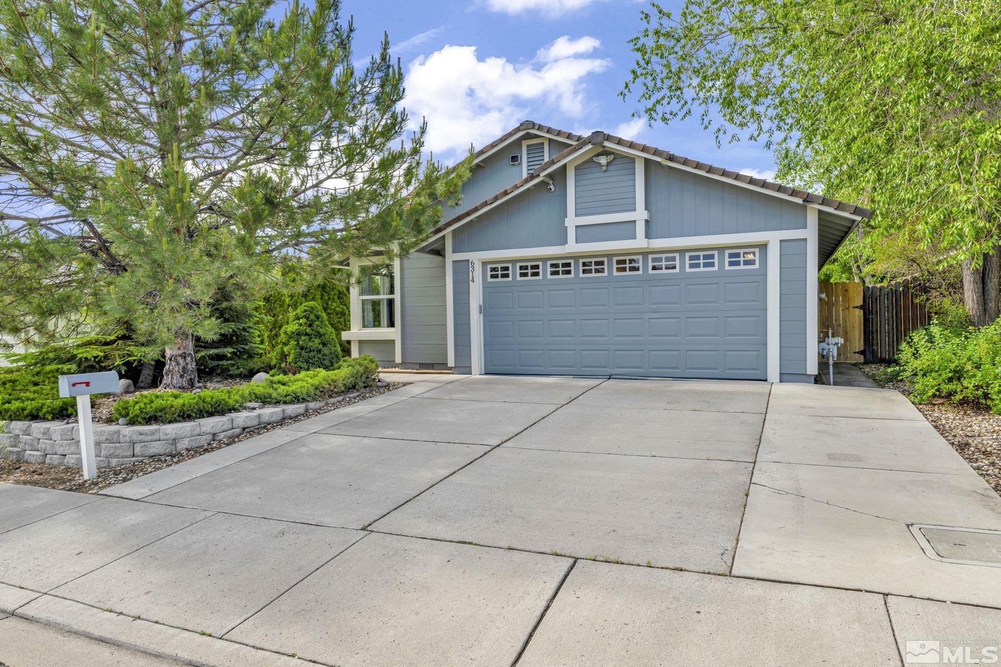 6314 Chesterfield Lane Reno, NV 89523 - Photo 1 of 35 a front view of a house with a garden