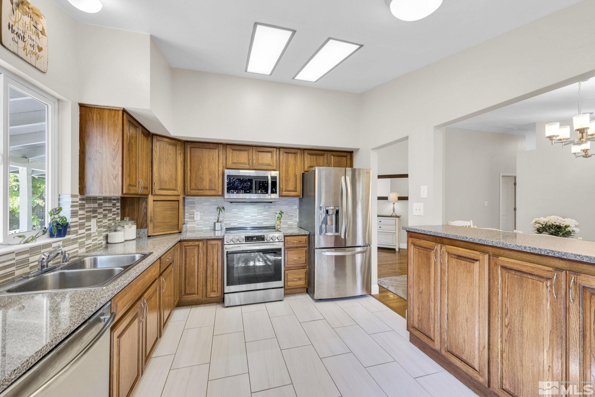 6314 Chesterfield Lane Reno, NV 89523 - Photo 13 of 35 a large kitchen with cabinets and stainless steel appliances